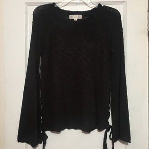 Flared knit sweater with braided sides.